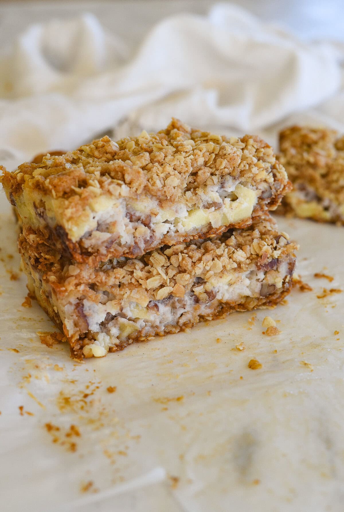 two sour cream apple bars stacked on top of eac other