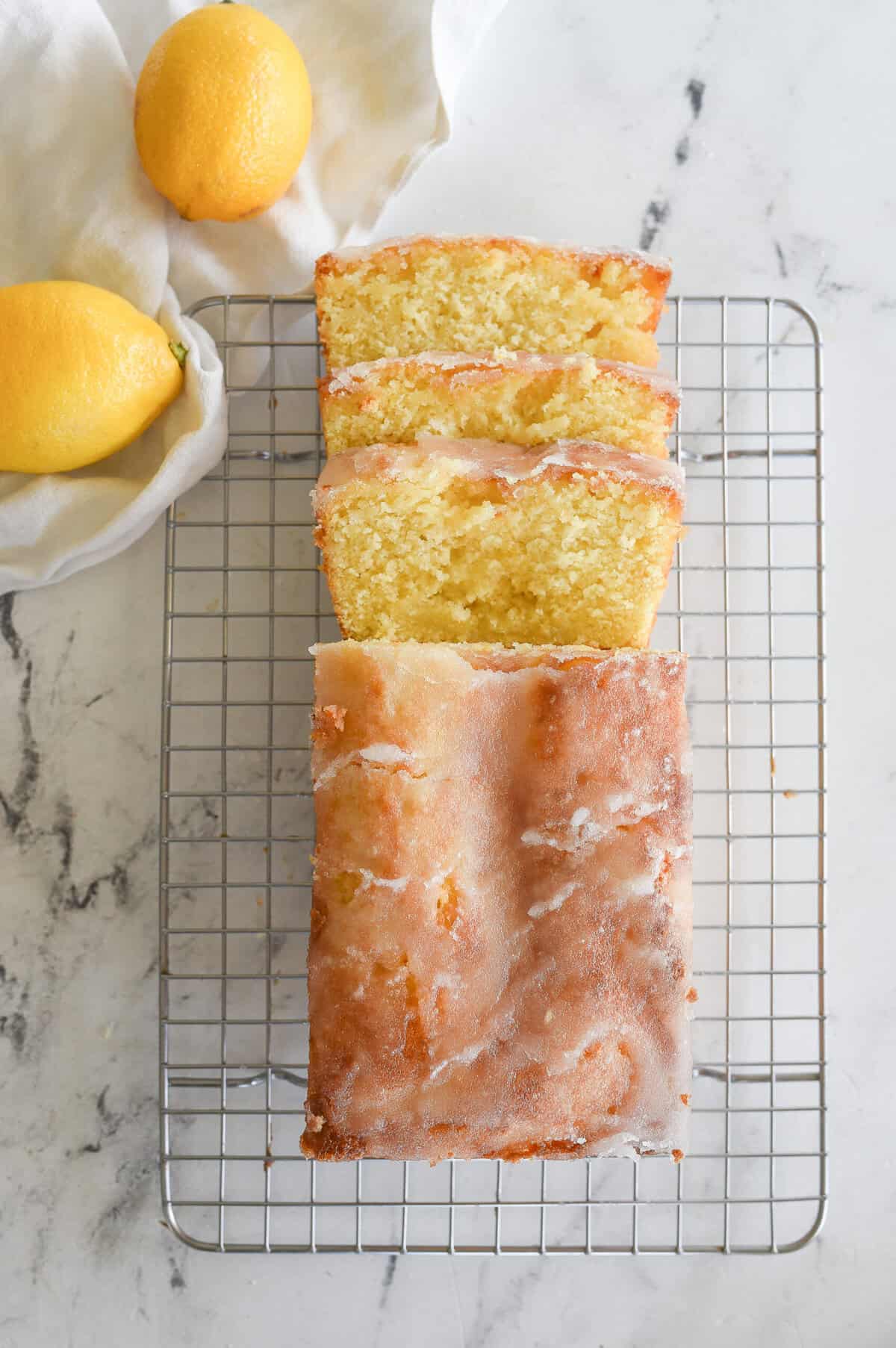 overhead shot of sliced lemon drizzle cake