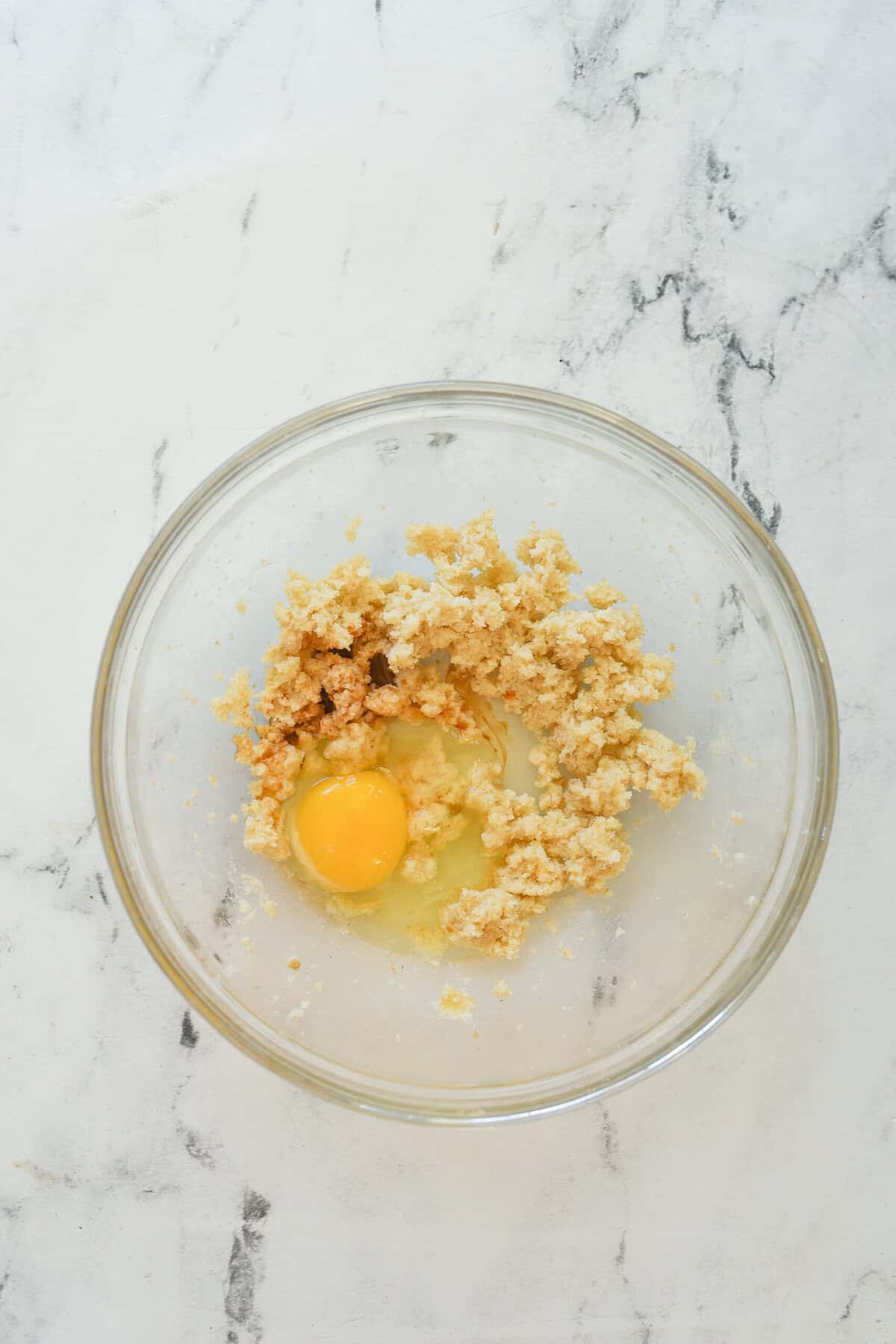adding egg to butter and sugar mixture