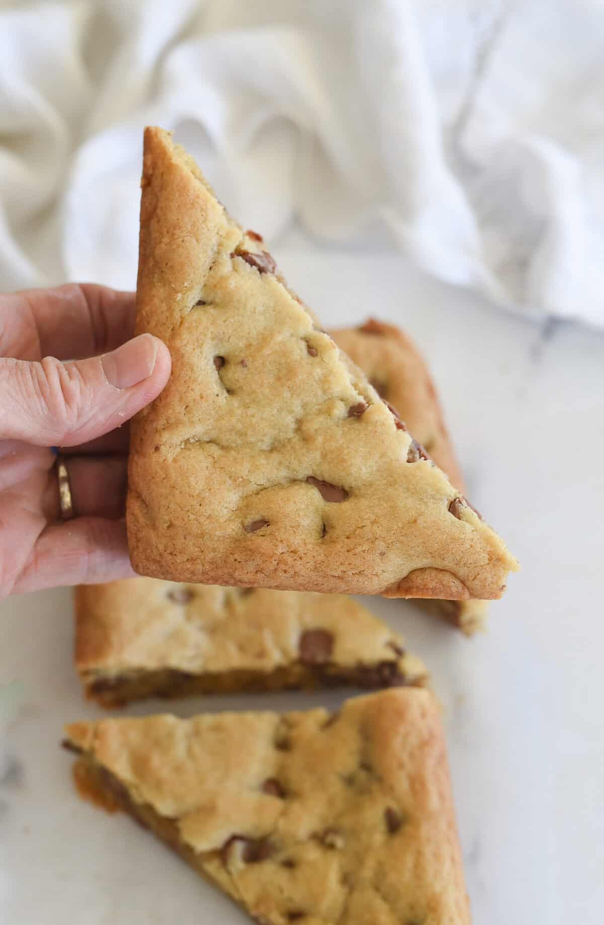 hand holding a chocolate chip cookie bar