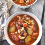 overhead shot of two bowls of minestrone soup