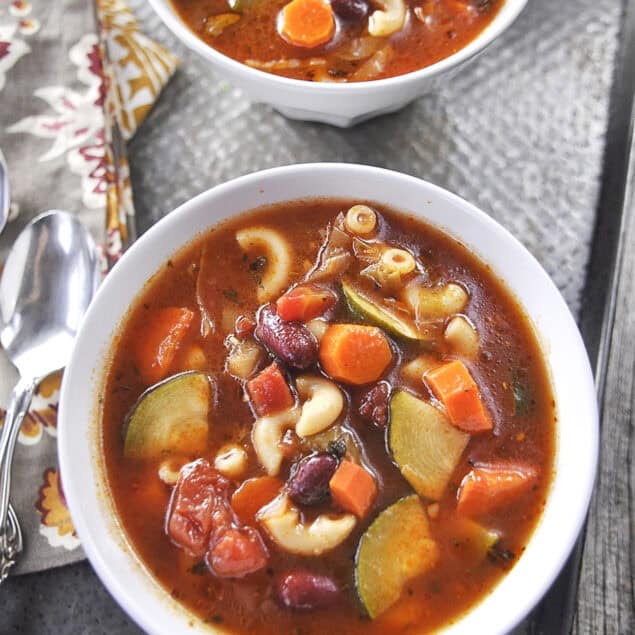overhead shot of two bowls of minestrone soup