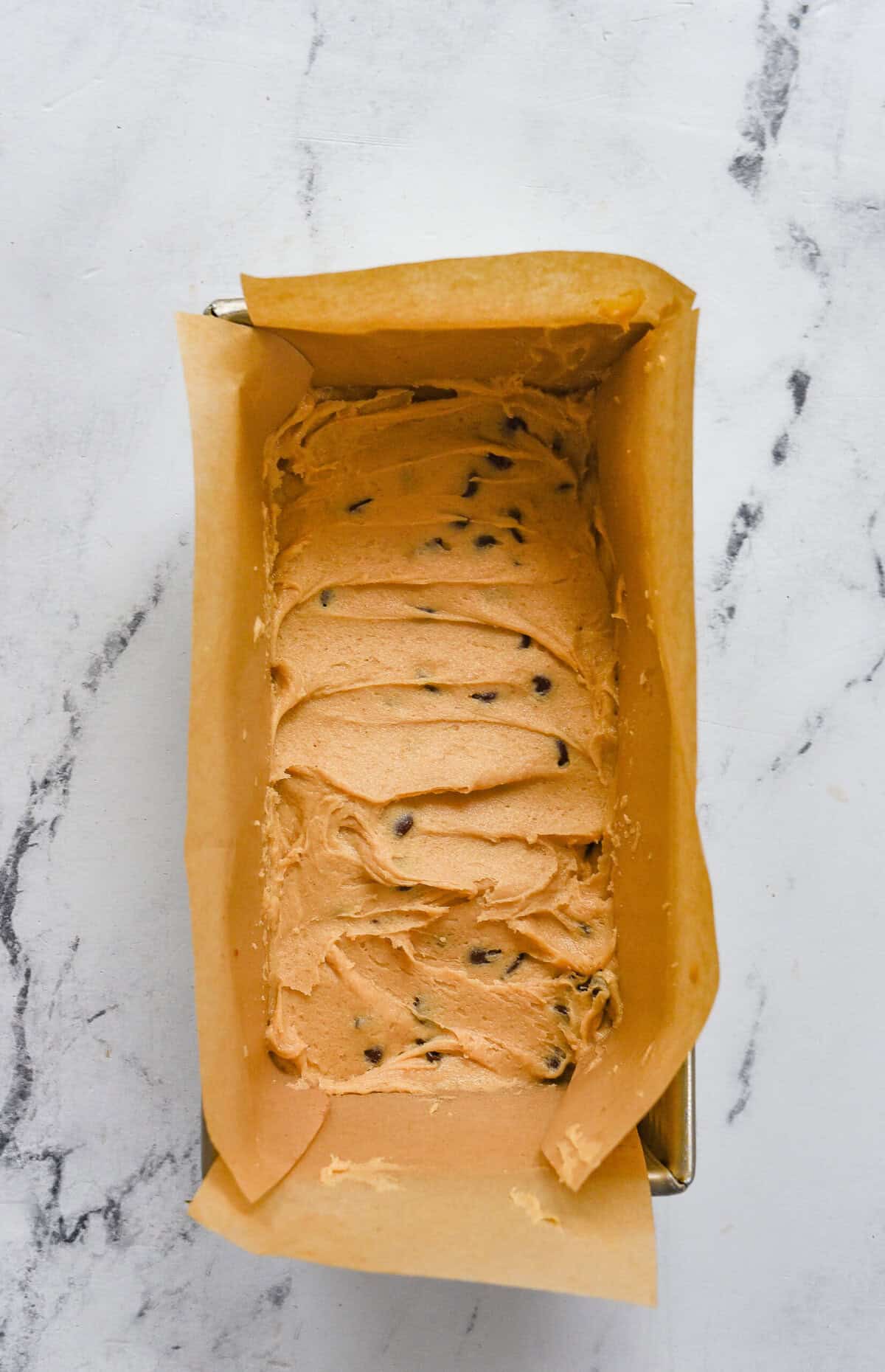 batter for peanut utter chocolate chip bars in a loaf pan